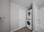 Thumbnail 7 of 72 - the living room has a washer and dryer and a door to the bathroom