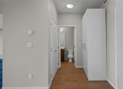 Thumbnail 14 of 72 - a corridor with white walls and a toilet in a bathroom