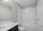 Thumbnail 15 of 72 - a bathroom with a shower and a sink and a toilet