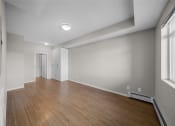 Thumbnail 11 of 72 - the living room is empty and has a wood floor and white walls