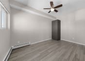 Thumbnail 41 of 48 - an empty living room with a ceiling fan and a closet
