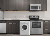 Thumbnail 44 of 48 - a kitchen with stainless steel appliances and a washing machine and a microwave