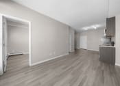 Thumbnail 46 of 48 - the living room and dining room of an apartment with wood flooring and white walls