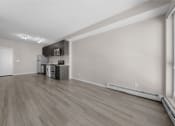 Thumbnail 40 of 48 - the living room and kitchen of an apartment with wood flooring and a large window