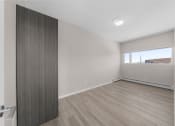 Thumbnail 32 of 48 - an empty living room with wood flooring and a window