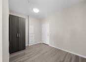 Thumbnail 31 of 48 - an empty room with a wardrobe and a door to a bathroom