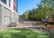 Thumbnail 27 of 48 - a courtyard with picnic tables and benches in front of a building