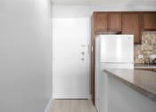 Thumbnail 22 of 33 - a kitchen with a white refrigerator and a counter top