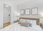 Thumbnail 19 of 78 - A bedroom with a large bed and three framed artworks on the wall.