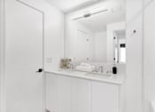 Thumbnail 25 of 78 - A white bathroom with a sink and mirror.