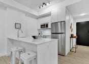 Thumbnail 24 of 78 - A modern kitchen with white cabinets and appliances.