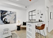 Thumbnail 7 of 78 - A modern living room with a large abstract painting on the wall, a black and white sofa, a coffee table, and a black floor lamp.