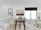 Thumbnail 45 of 78 - A modern dining room with a wooden table and chairs.
