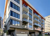 Thumbnail 76 of 78 - A modern multi-story residential building with balconies and a mix of window sizes.