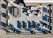 Thumbnail 75 of 78 - A patio with a table and chairs is shown from an aerial perspective.