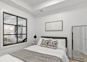 Thumbnail 2 of 78 - A bedroom with a large bed and a large mirror.