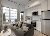 Thumbnail 59 of 78 - A modern kitchen with a grey couch and a stainless steel refrigerator.