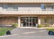 Thumbnail 26 of 33 - the front of a building with glass doors and a sidewalk