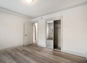 Thumbnail 66 of 219 - A room with a white door and a mirror on the wall.