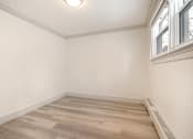 Thumbnail 58 of 219 - A room with a window and a wooden floor.