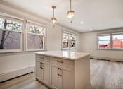 Thumbnail 28 of 219 - A kitchen with a white countertop and cabinets.