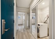 Thumbnail 73 of 219 - A hallway with a washing machine in the doorway.