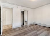 Thumbnail 68 of 219 - A room with a white wall and a wooden floor.
