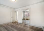 Thumbnail 67 of 219 - A room with a wooden floor and a sliding door.
