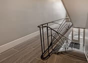 Thumbnail 206 of 219 - A staircase with a metal railing and wooden steps.