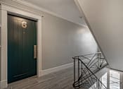Thumbnail 205 of 219 - A staircase with a metal railing and a wooden floor.