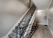 Thumbnail 194 of 219 - A staircase with a metal railing and steps made of stone or tile.