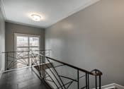 Thumbnail 191 of 219 - A staircase with a metal railing and wooden steps.