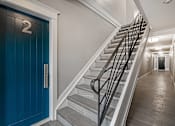 Thumbnail 214 of 219 - A staircase with a blue door and a number 2 on it.