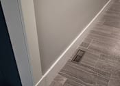 Thumbnail 218 of 219 - A corner of a room with a tiled floor and a drain in the floor.
