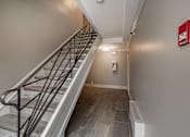 Thumbnail 208 of 219 - A staircase with a metal railing and wooden steps.