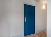 Thumbnail 164 of 219 - A blue door in a room with white walls.