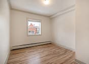 Thumbnail 176 of 219 - A room with a window and wooden flooring.