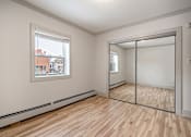 Thumbnail 174 of 219 - A room with a wooden floor and a large mirror.