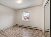 Thumbnail 171 of 219 - A room with a window and a wooden floor.