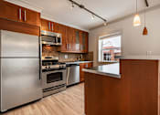 Thumbnail 163 of 219 - A kitchen with wooden cabinets and stainless steel appliances.