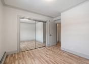 Thumbnail 169 of 219 - A room with a white wall and a wooden floor.