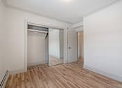 Thumbnail 168 of 219 - A room with a white wall and a wooden floor.