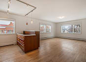 Thumbnail 162 of 219 - A room with a wooden floor and a brown desk.