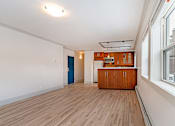 Thumbnail 181 of 219 - A room with a wooden floor and a blue door.