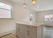 Thumbnail 137 of 219 - A kitchen with a white countertop and cabinets.