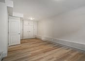 Thumbnail 135 of 219 - A room with wooden flooring and white walls.