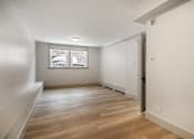 Thumbnail 133 of 219 - A room with wooden flooring and a window.