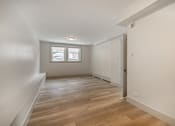Thumbnail 132 of 219 - A room with wooden flooring and a window.