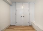 Thumbnail 131 of 219 - A white door with a handle and a lock is in the middle of a room.