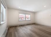 Thumbnail 120 of 219 - A room with a window and wooden flooring.